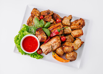 Grilled meat platter with fresh herbs and sauce