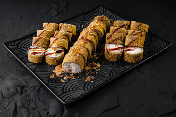 Delectable assorted sushi rolls on elegant black plate