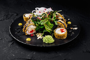 Gourmet sushi roll platter on dark background