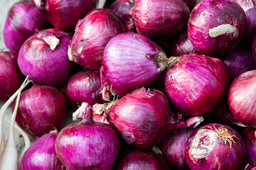 Pile of purple onions in market