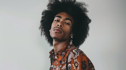 beautiful portrait of a young afro american male model with cute earrings, in the style of seventies, posing on camera, fashion style - 787043814