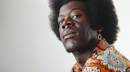 beautiful portrait of a young afro american male model with cute earrings, in the style of seventies, posing on camera, fashion style - 787043841