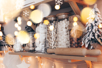 Shelves with glass jars filled with sweets in candy store or coffee shop during Christmas holidays