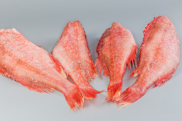 Frozen redfish carcasses with hoarfrost on gray surface, side view - 787046226