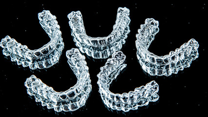 Invisible aligners teeth retainers lie on the mirror