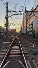 Fototapeta na wymiar Sunset at a Japanese railway crossing