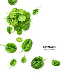 Fresh spinach leaves pile top view isolated on white background.