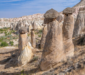 Fairy chimneys, unique rock formations near Cavusin Town in Cappadocia, Turkey..