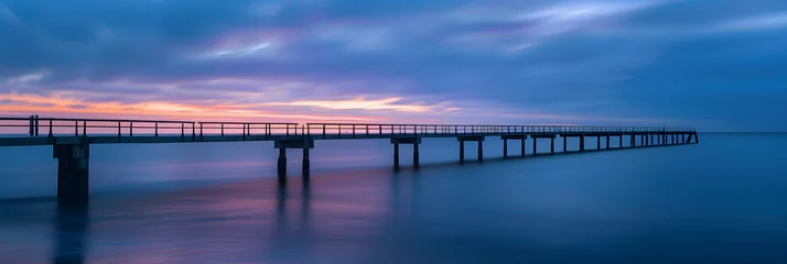  a bridge over the ocean at sunset © john