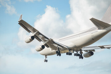 Close up of a massive cargo plane is preparing to land in the sky, amidst the clouds. Landing...