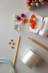 Various craft supplies on white background. Supplies for jewelry making, drawing and needlework. Flat lay.