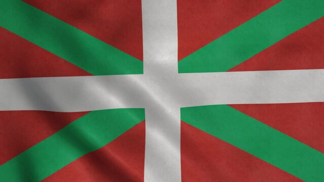 The Basque Country flag waving. Spanish autonomous community. White cross over green saltire on a red field