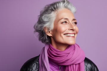 Portrait of a blissful woman in her 50s dressed in a water-resistant gilet on pastel purple...