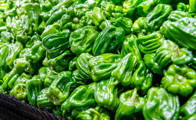 Pile of green peppers in the market