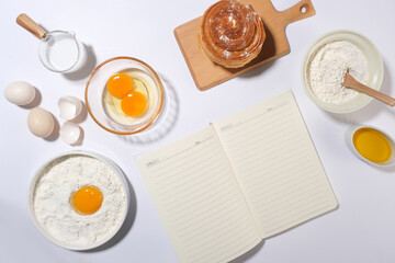 Photo for baking concept, blank paper for adding text, a cinnamon roll featured on wooden tray with...