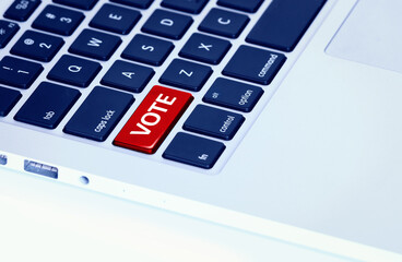 Closeup of a laptop keyboard with a red vote button