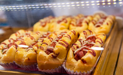 Group of hot dogs on the bakery shelf