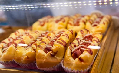 Gordijnen Group of hot dogs on the bakery shelf © xy