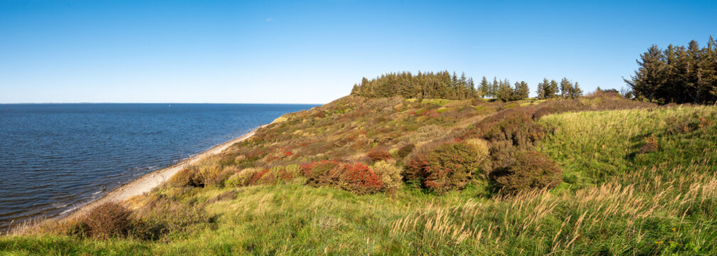 Autumn view of west coast cliffs and covered hills on Livo island, Limfjord, Nordjylland, Denmark
