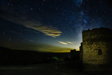 night photography of a castle at night and the Milky Way and starry sky