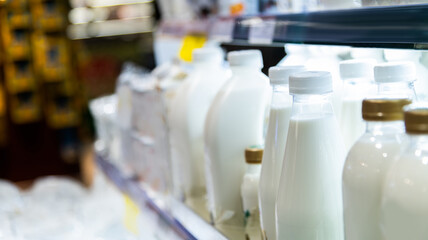 Milk bottles on the supermarket shelf