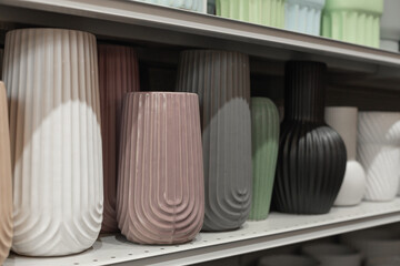 ceramic vases for fresh cut flowers and floral arrangements on a shelf in a store, sale in a home decor store
