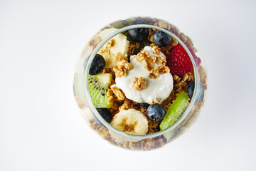delicious crunchy granola dessert with berries and fruits on a white background