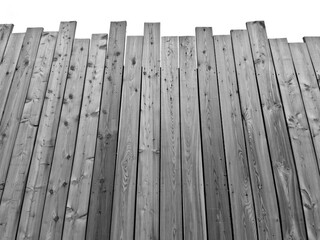 a boarded lot with a palisade at the bottom. the top of the fence is jagged from boards like an...