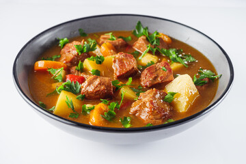 fragrant thick goulash soup on a white background