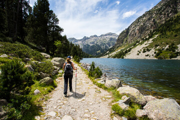 Fototapeta premium Young hiker woman in Vall de Boi, Aiguestortes and Sant Maurici National Park, Spain