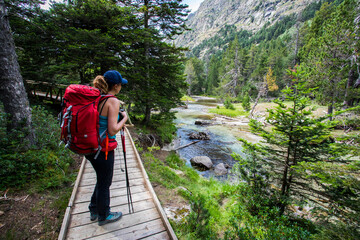 Young hiker woman in Vall de Boi, Aiguestortes and Sant Maurici National Park, Spain