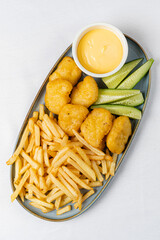 french fries with nuggts and cheese sauce - 787079875