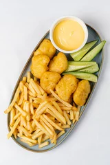 Plexiglas foto achterwand french fries with nuggts and cheese sauce © Maksim Shebeko