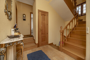 Interior wooden stairs in a house with wooden furniture, oak carpentry on doors and railings of the...