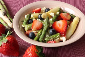 Springtime Delight: Strawberry, Asparagus, and Feta Salad with Honey Mustard Dressing on a Pink Background