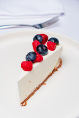 cheesecake with berries on the white