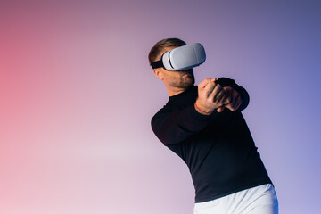 A man in a VR headset swings a baseball bat while blindfolded in a studio setting, showcasing virtual reality sports training.