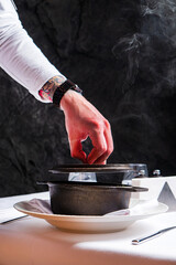 Chef cooking soup in the kitchen at restaurant. - 787084003