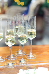 Glasses of sparkling wine on wooden table on Christmas