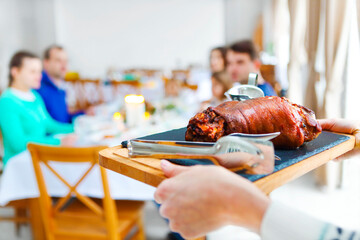 Friends sitting around a table and enjoying Christmas dinner together
