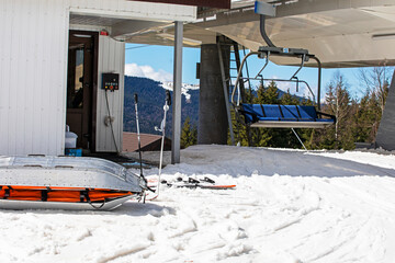 rescue sled for injured skiers near the ski slope on a sunny day. Active and relaxing holiday