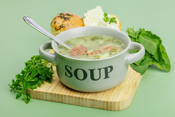 Traditional Portuguese soup Caldo Verde with fresh bakery. Aromatic greens, served dish