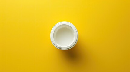 Round styrofoam food container on a yellow background