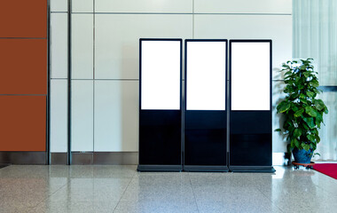 Three touch display kiosks in a row at  airport