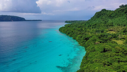 Fiji Islands. Turquoise waters of ocean wash island covered tropical vegetation. Travel concept.