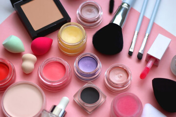 Various colorful beauty products on bright pink background. Selective focus.