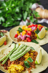 set of delicious fresh colorful tacos on a dark background
