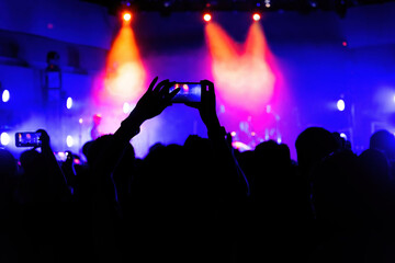 People using mobile phone camera at a concert