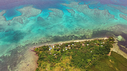 Fiji Islands. Turquoise waters of ocean wash island covered tropical vegetation. Travel concept.