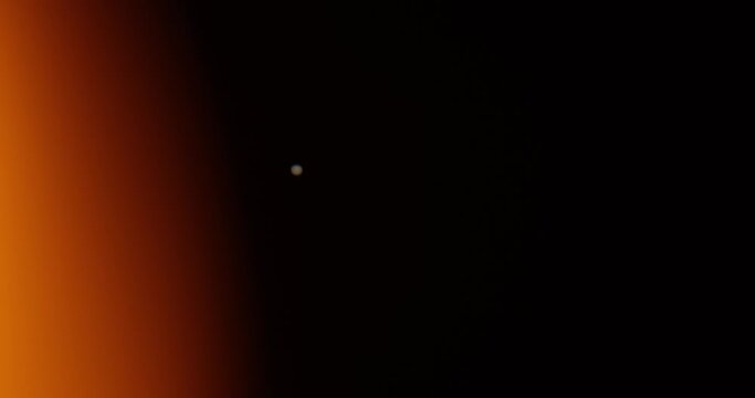 Real video of Jupiter's movement against the backdrop of a bright orange spot similar to the sun